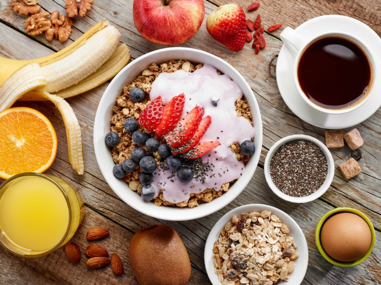 Granola, oats, yogurt and fruit with coffee