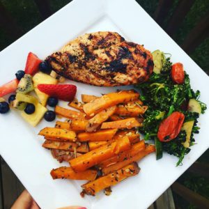 Grilled chicken, fruit, salad and sweet potato fries